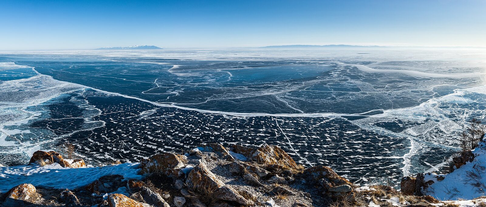 Frozen Lake Baikal seen from Olkhon Island, black ice laced with white fractures