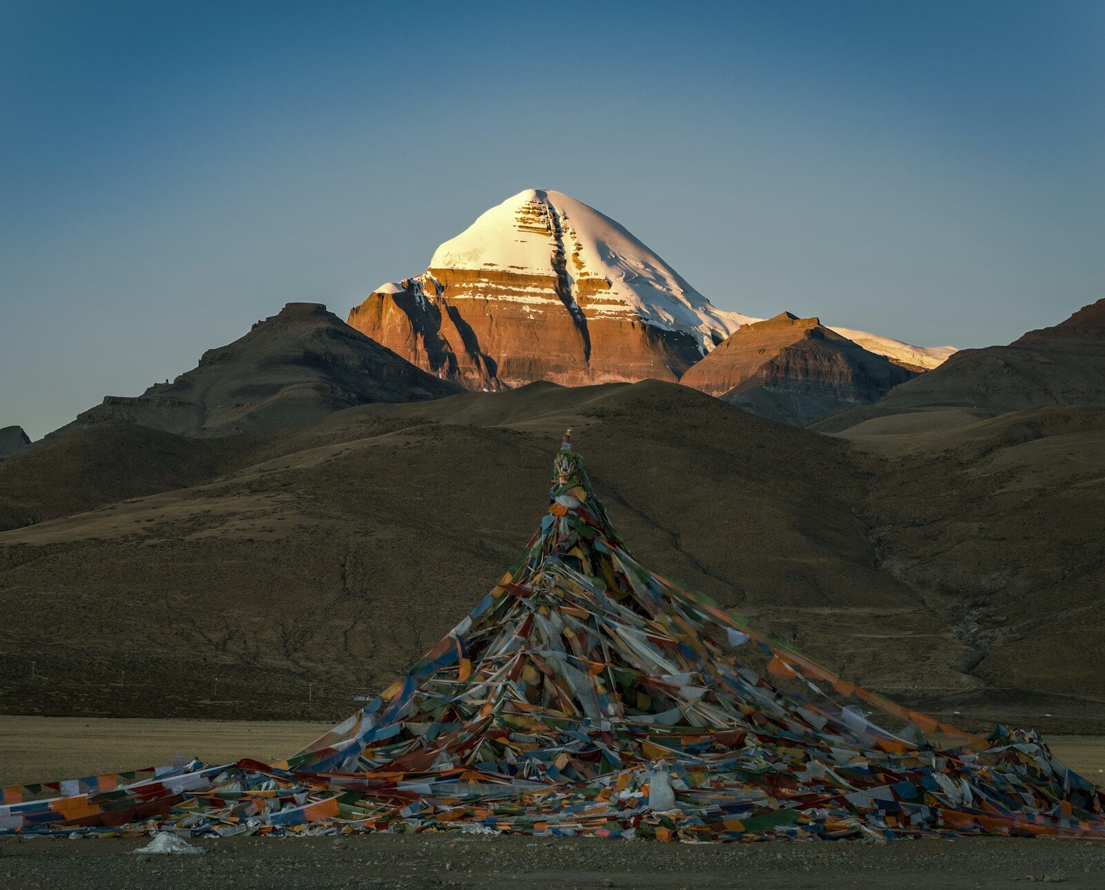 Mount Kailash at sunrise with Tibetan prayer flags in the foreground